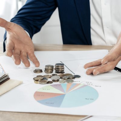 close-up-man-with-coins-statistics